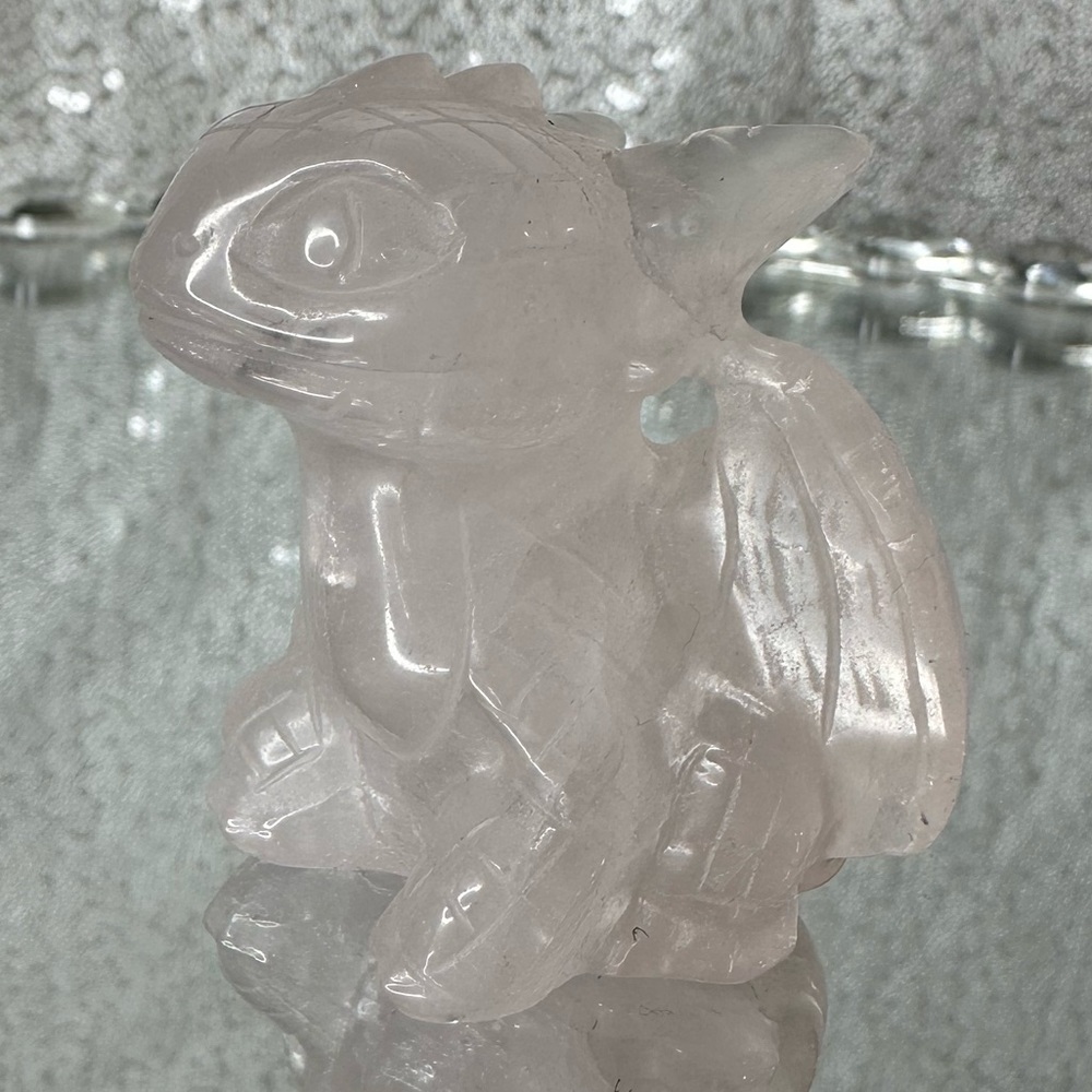 Rose quartz toothless crystal carving with little bits of rainbow and flash